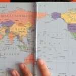 World map showing the seven continents outlined in different colors