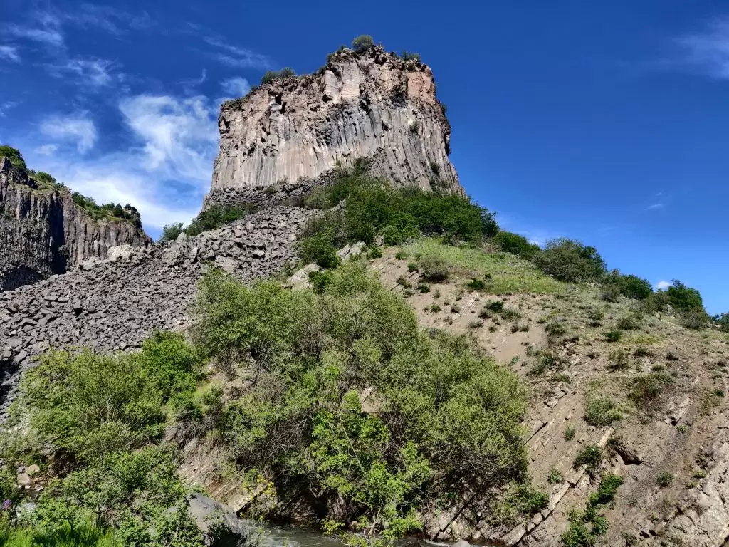 Hexagonal basalt columns at Garni Gorge in Armenia, with Garni Temple ruins perched above the canyon.