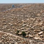Aerial view of the densely packed tombs and mausoleums of Wadi al-Salam Cemetery in Najaf, Iraq.