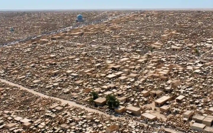 Aerial view of the densely packed tombs and mausoleums of Wadi al-Salam Cemetery in Najaf, Iraq.