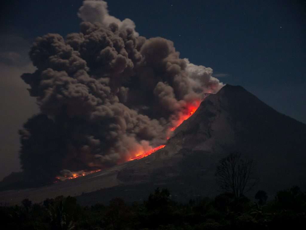 Illuminated night eruption of Mount Sinabung in 2014, West Sumatra, Indonesia.