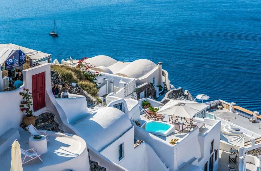 Whitewashed Santorini cliffside villas with a private plunge pool overlooking the deep-blue Aegean Sea