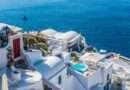 Whitewashed Santorini cliffside villas with a private plunge pool overlooking the deep-blue Aegean Sea