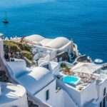 Whitewashed Santorini cliffside villas with a private plunge pool overlooking the deep-blue Aegean Sea