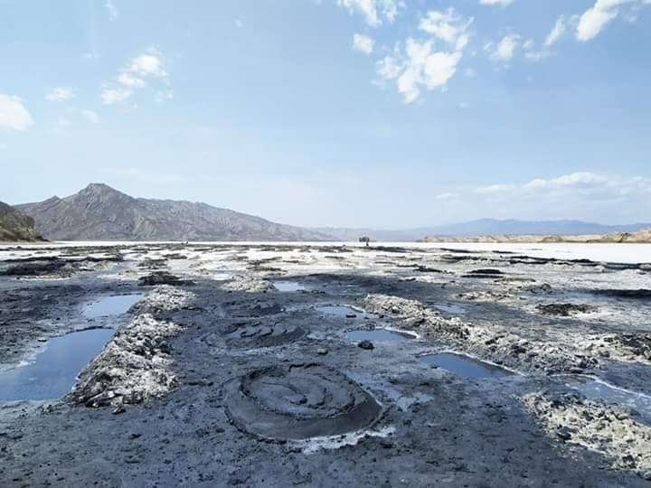 Close-up of concentric mud volcano cones at Oksukon Lake’s shoreline