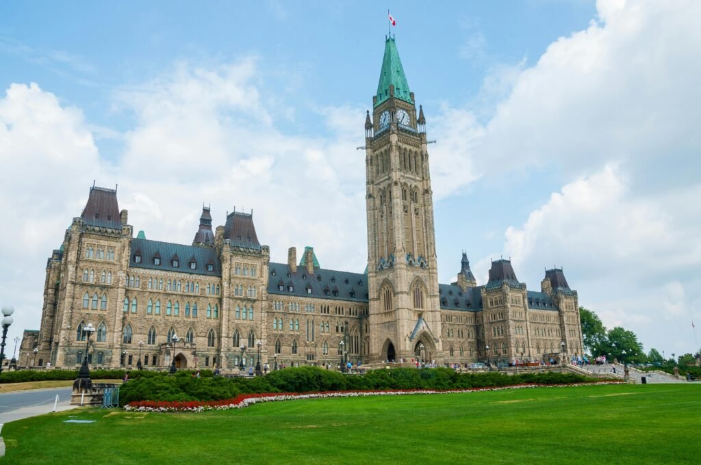 Parliament Hill in Ottawa, Canada with the iconic Peace Tower under a blue sky.