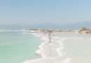 Woman walking on salt formations at the Dead Sea