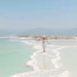 Woman walking on salt formations at the Dead Sea