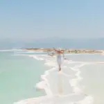 Woman walking on salt formations at the Dead Sea