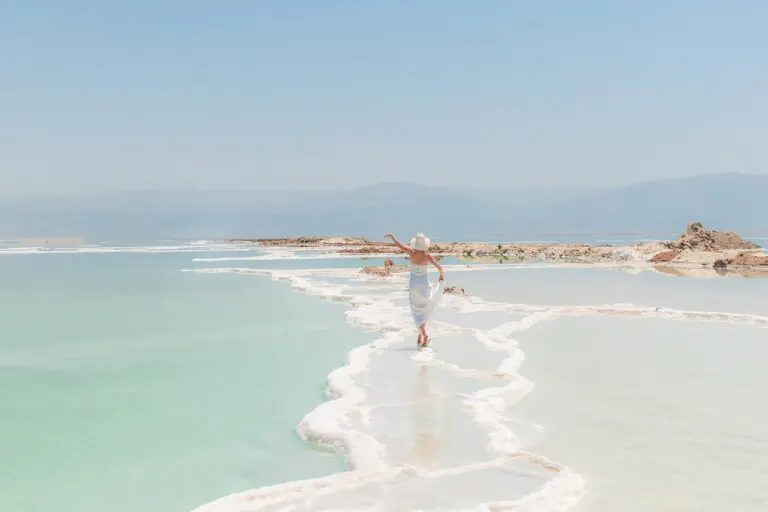 Woman walking on salt formations at the Dead Sea