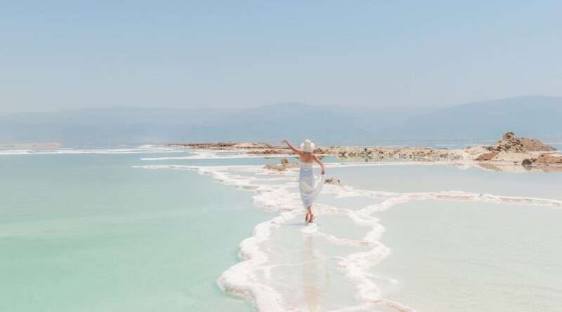 Woman walking on salt formations at the Dead Sea