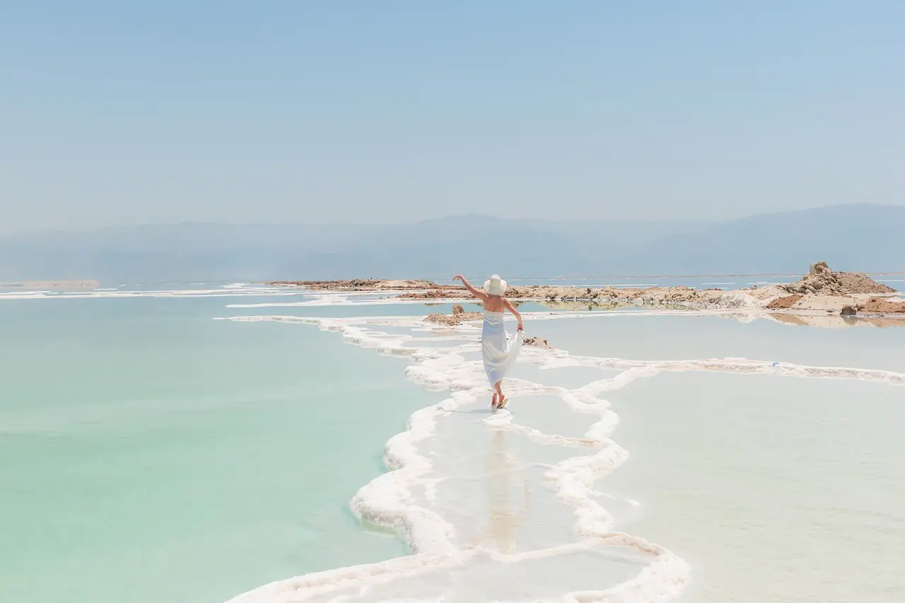 Woman walking on salt formations at the Dead Sea