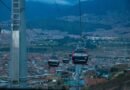TransMiCable cabins over Ciudad Bolívar, Bogotá, linking hillside barrios to the city at dusk