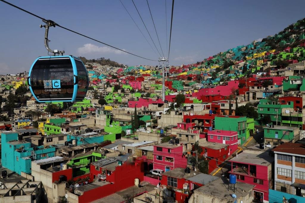 Cablebús Line 2 cabin over Iztapalapa’s colorful hillside neighborhoods in Mexico City