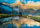 Sunrise on the Dhauladhar Range reflected in a hilltop pond at Triund, Himachal Pradesh, India.