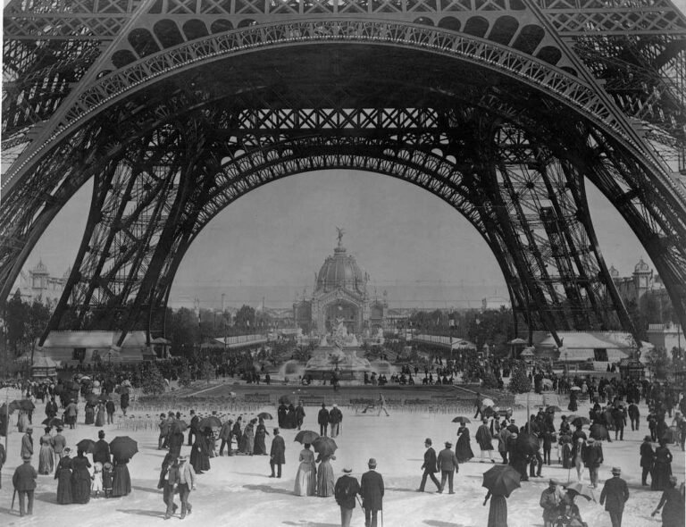 Crowds beneath the Eiffel Tower’s arches at the 1889 Exposition Universelle, Paris