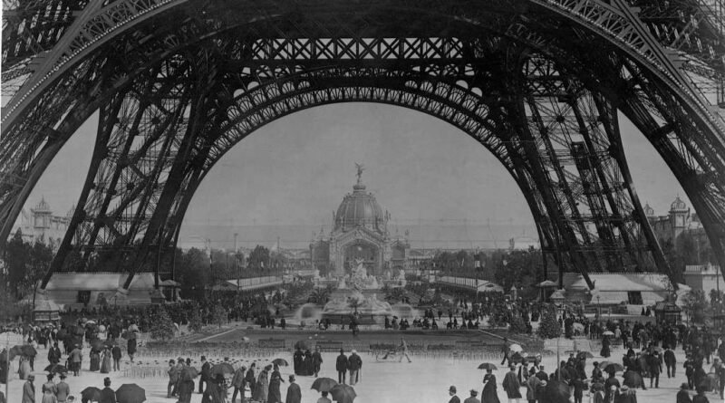 Crowds beneath the Eiffel Tower’s arches at the 1889 Exposition Universelle, Paris