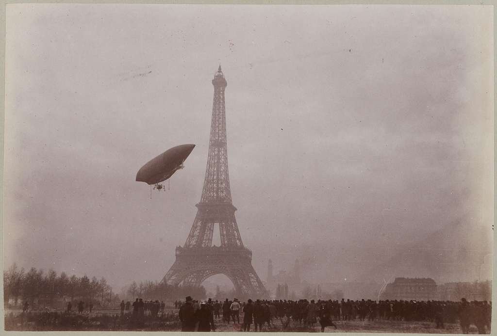 Early airship flying past the Eiffel Tower in Paris, early 1900s