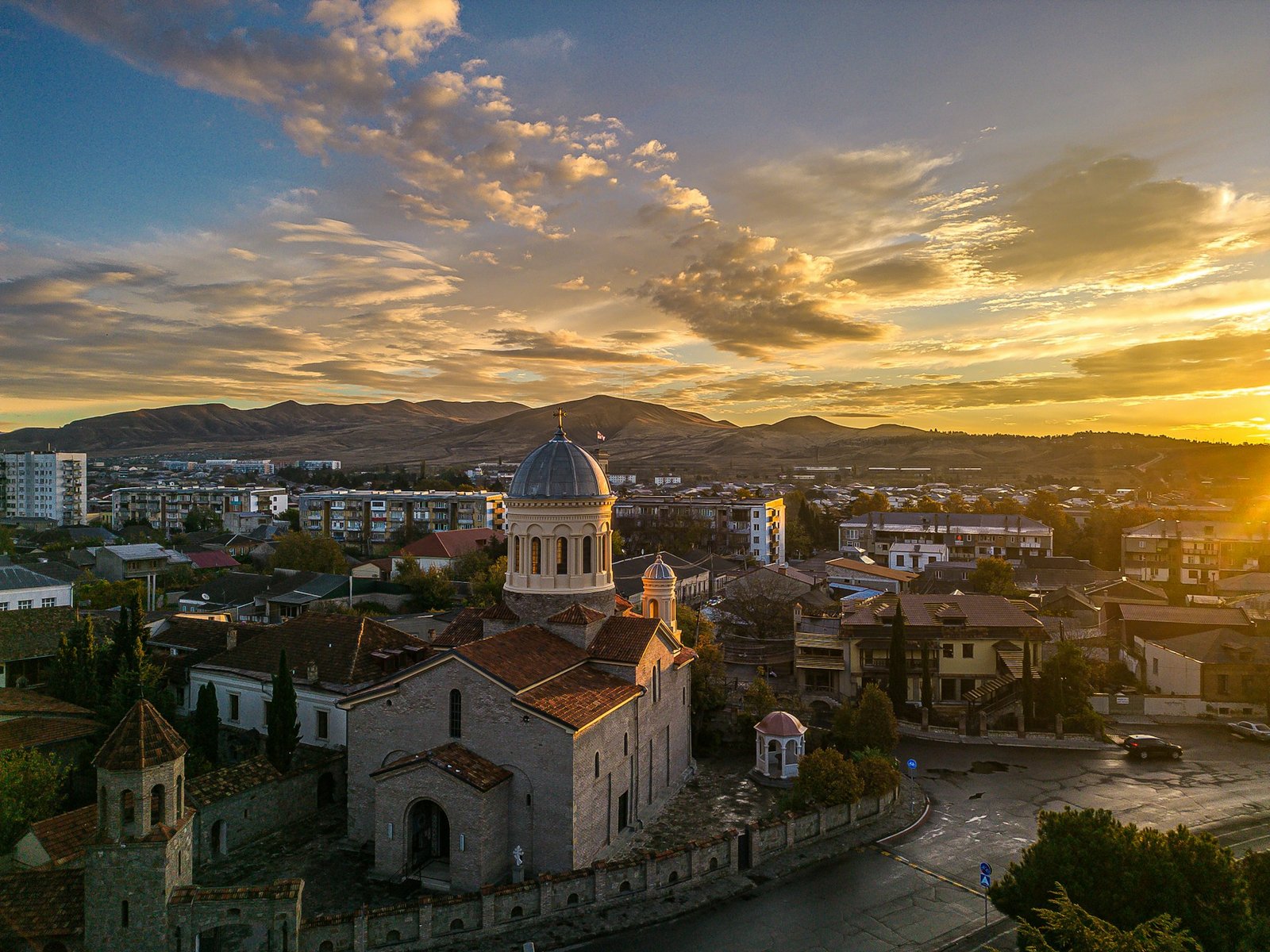 Sunset skyline of Gori, Georgia, with the Cathedral of the Nativity and the foothills of the Trialeti Range