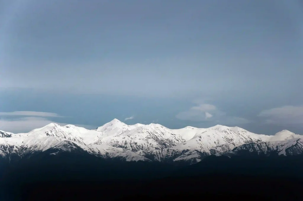 Snow-covered Caucasus Mountains rising above Georgia’s Alazani Valley in a wide landscape view