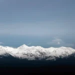 Snow-covered Caucasus Mountains rising above Georgia’s Alazani Valley in a wide landscape view