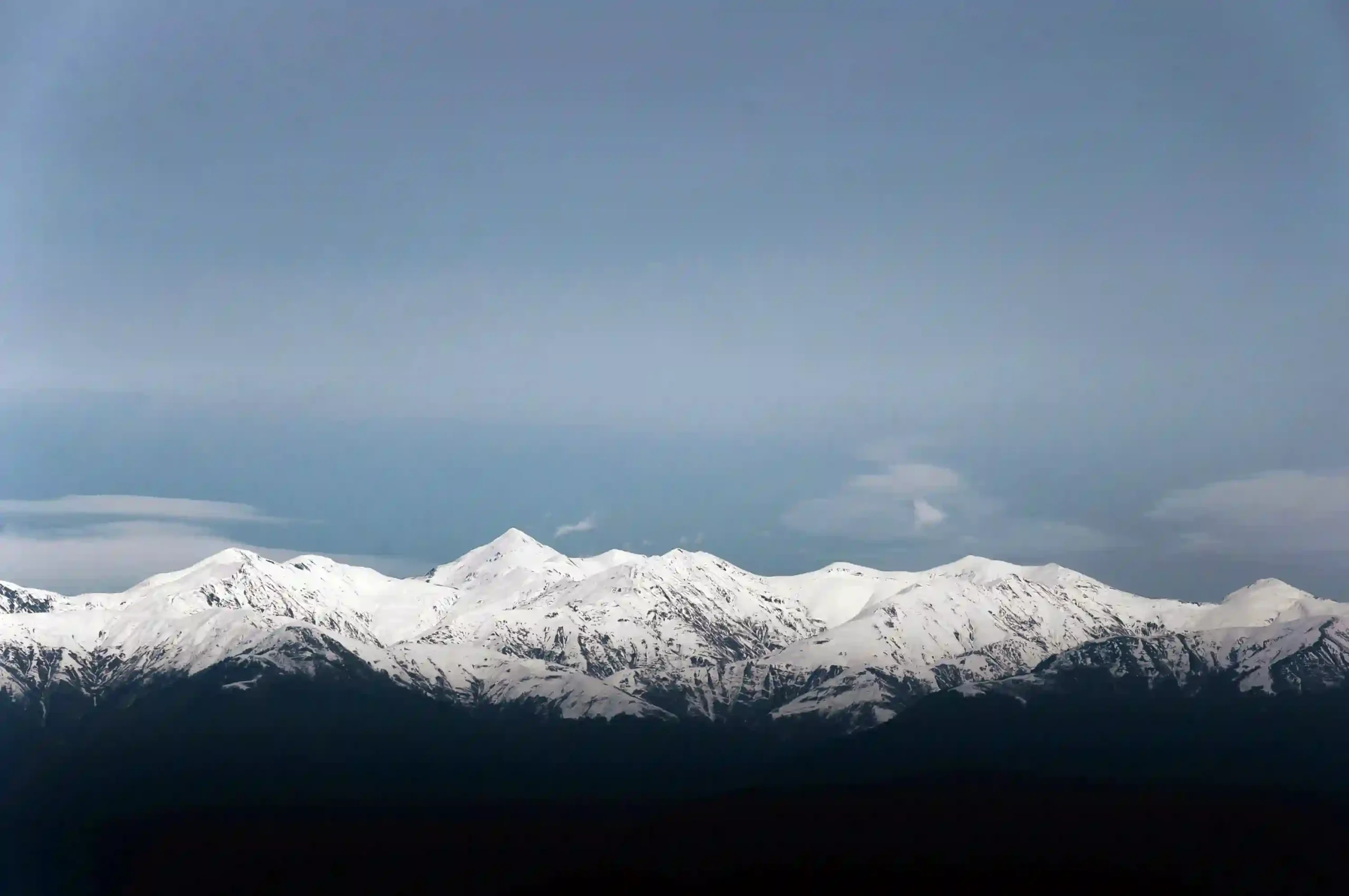 Snow-covered Caucasus Mountains rising above Georgia’s Alazani Valley in a wide landscape view