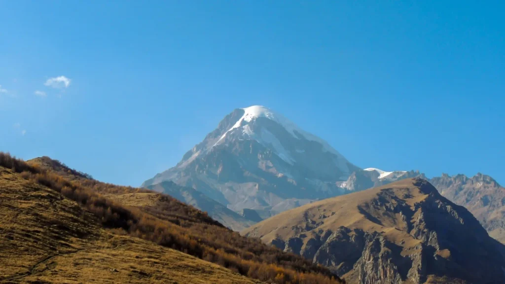 Mount Kazbek rising above dry highland slopes in the central Greater Caucasus