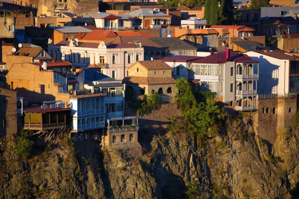 Historic buildings on the cliffs above the Mtkvari River in Old Tbilisi, GeorgiaTitle: Old Tbilisi Cliffside Buildings Above the Mtkvari River